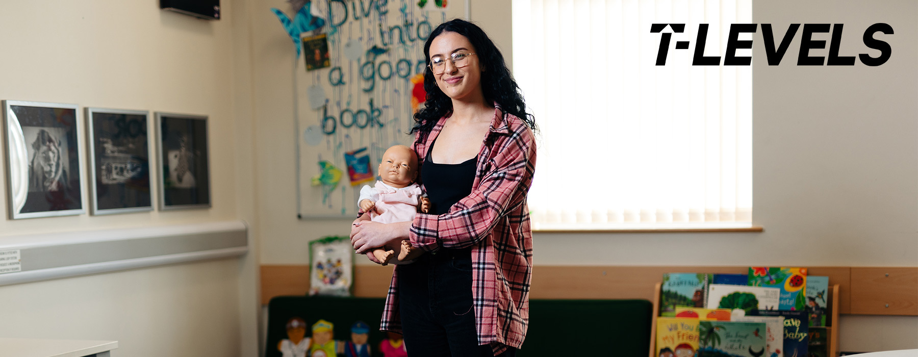 Childcare and Education T Level student holding baby