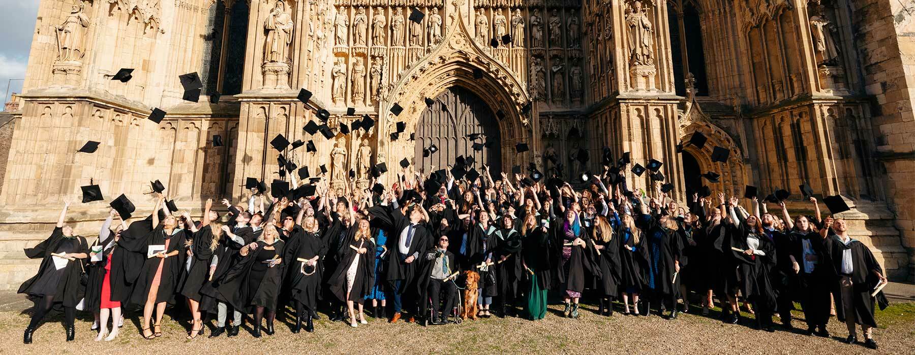 Graduates throwing caps into the air