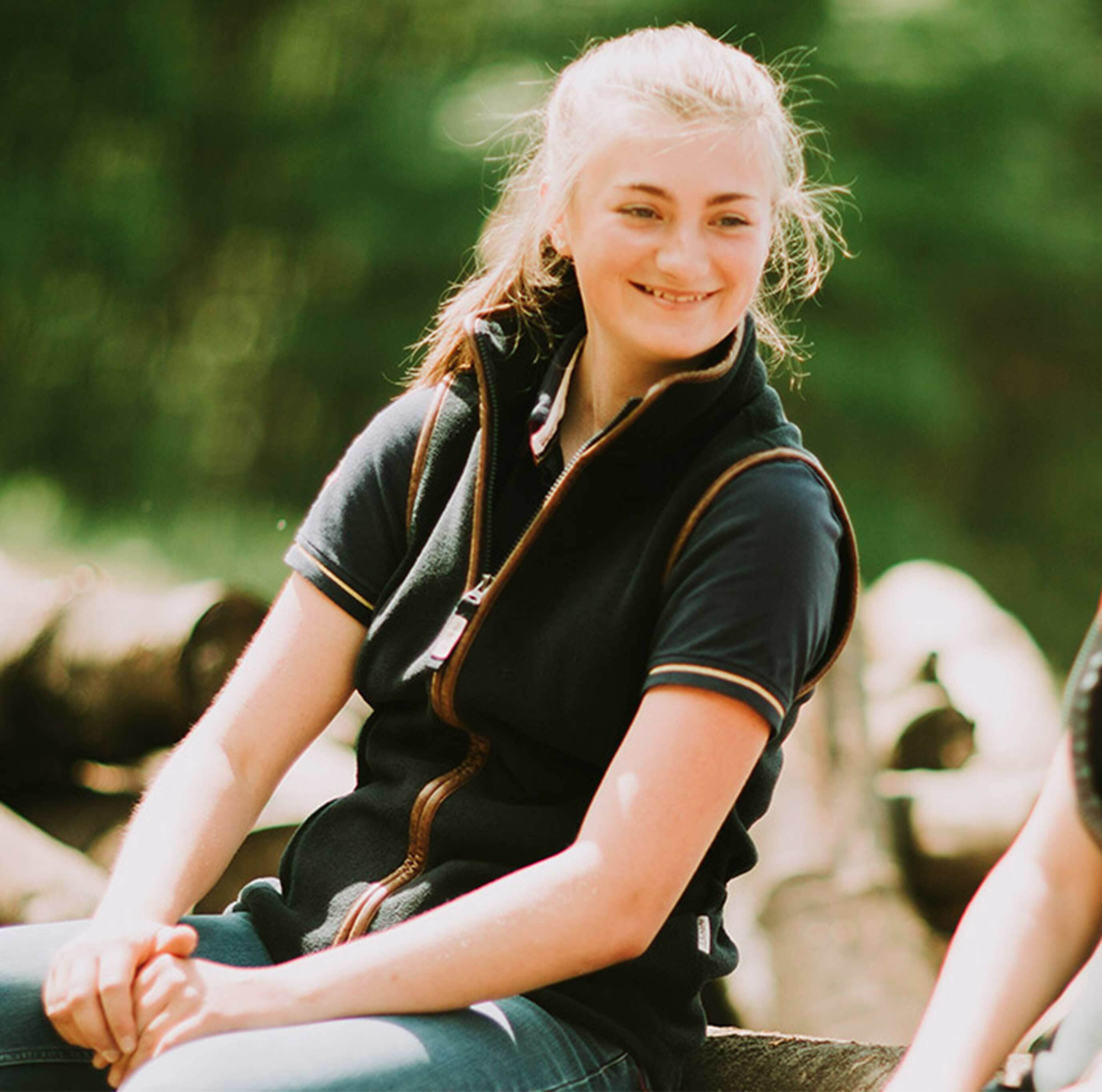 Agric students sitting on log thumb