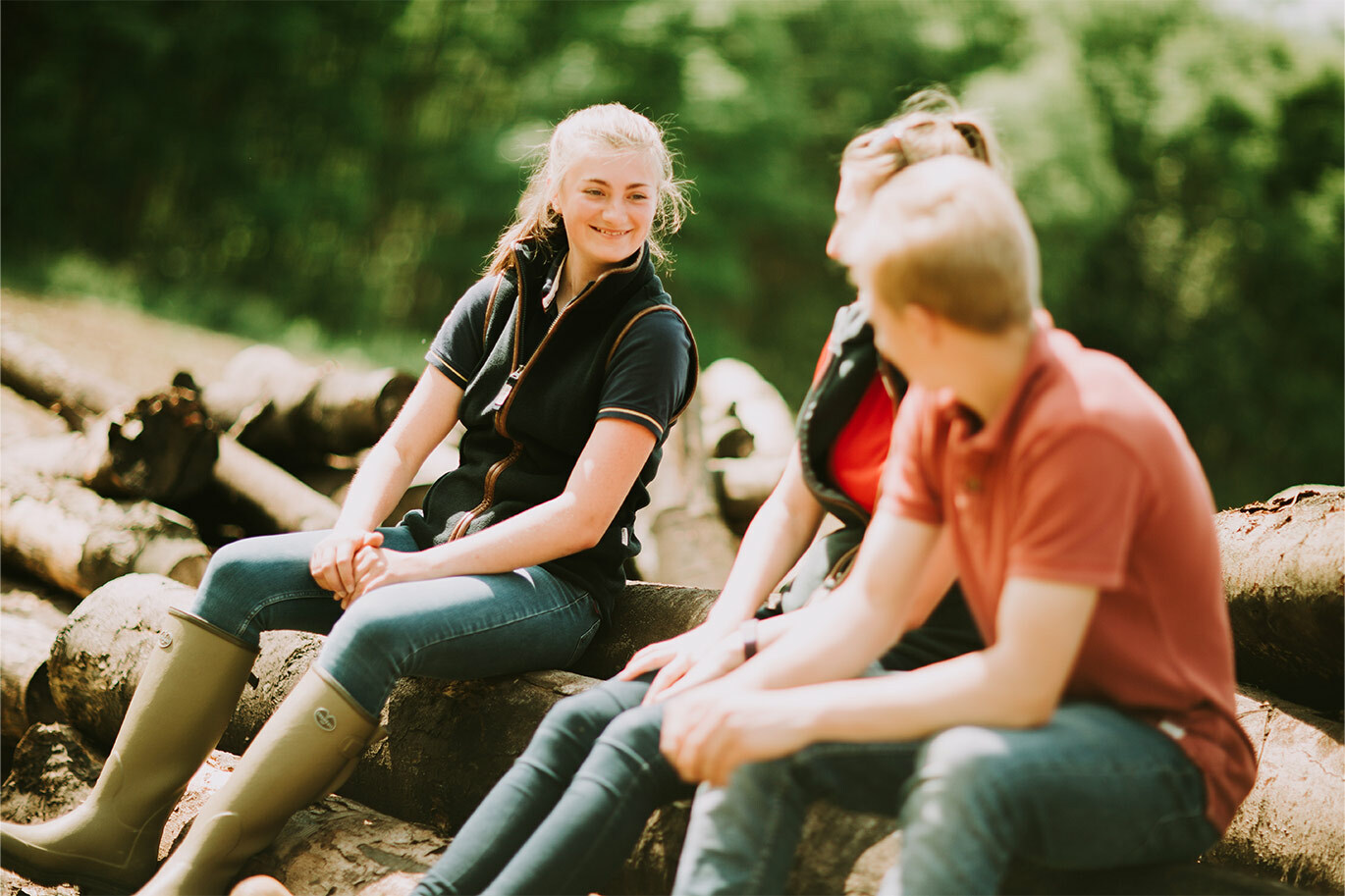 Agriculture students sitting on log talking