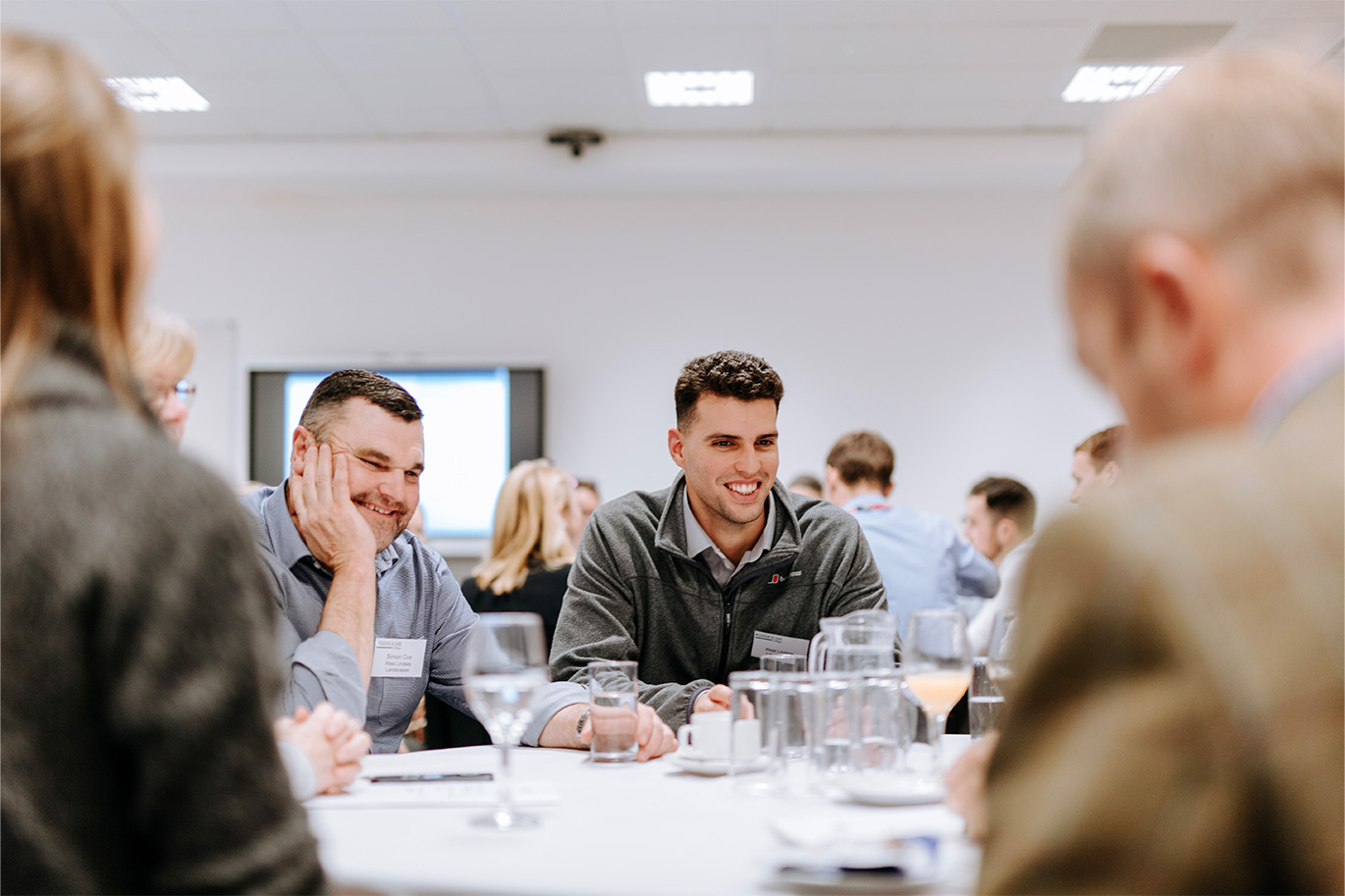 Delegates sitting around a table in conference area