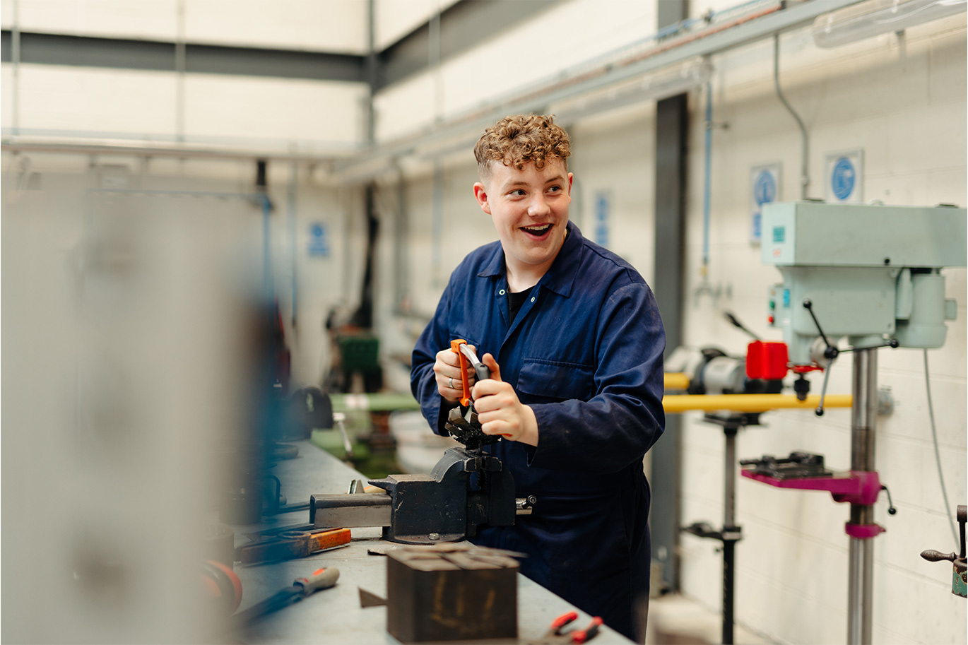 Engineering student at table top vise
