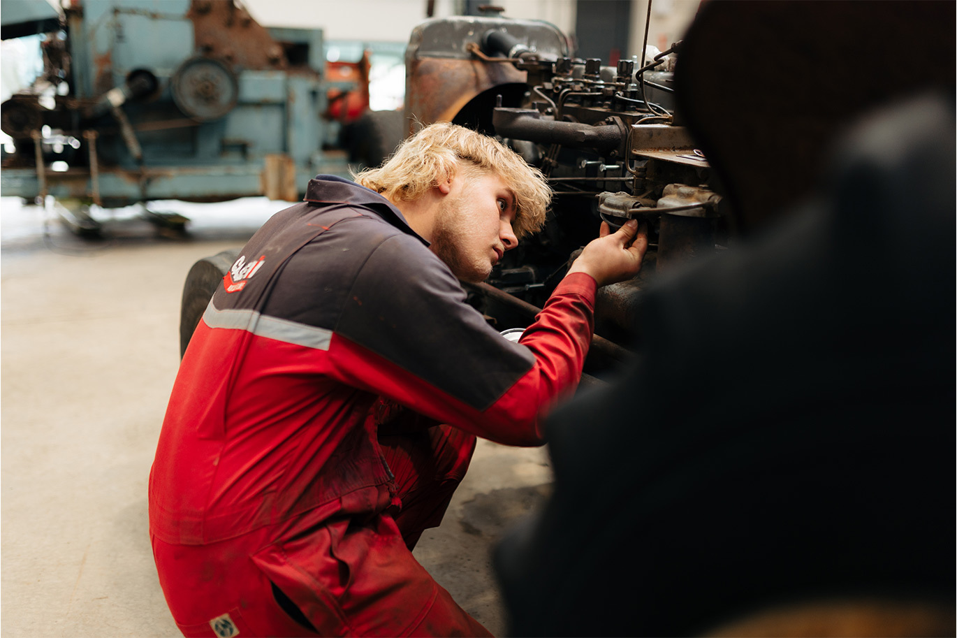 Engineering student fixing an engine