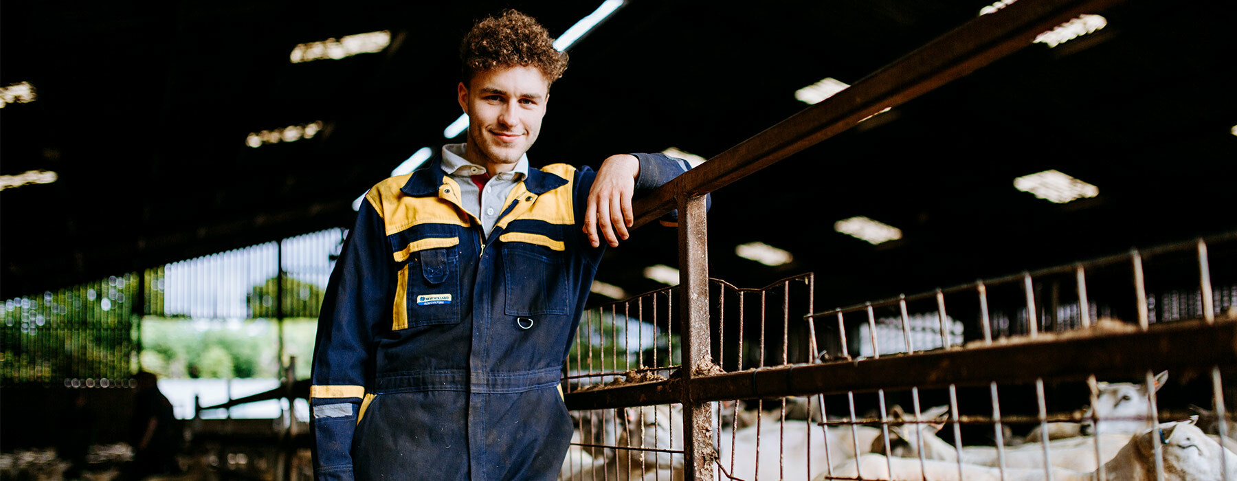 Higher Education Agric student leaning on fence