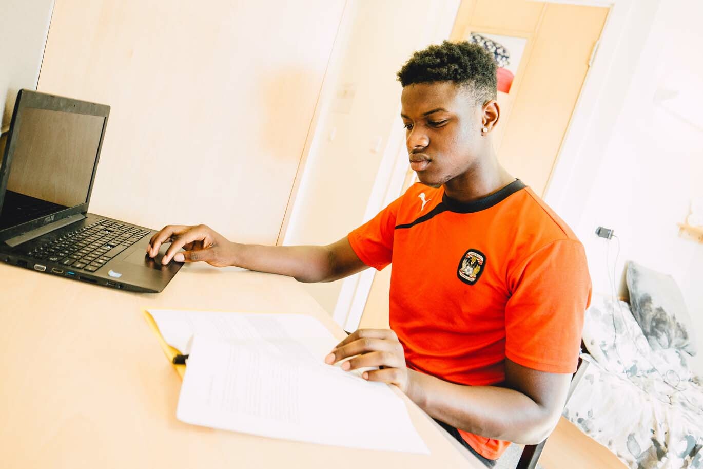 Male student working in his room at Riseholme College