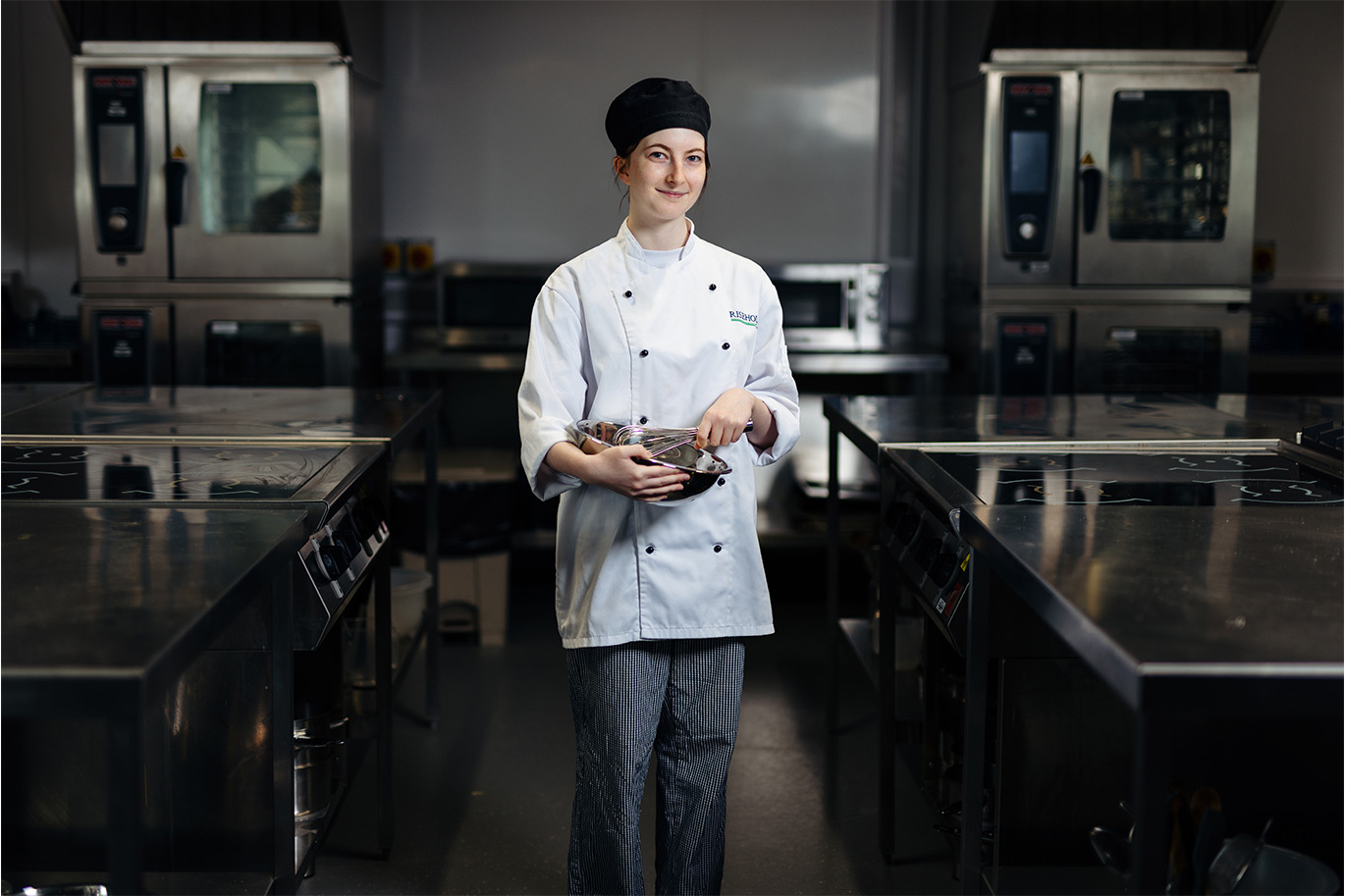 Professional cookery student in kitchen