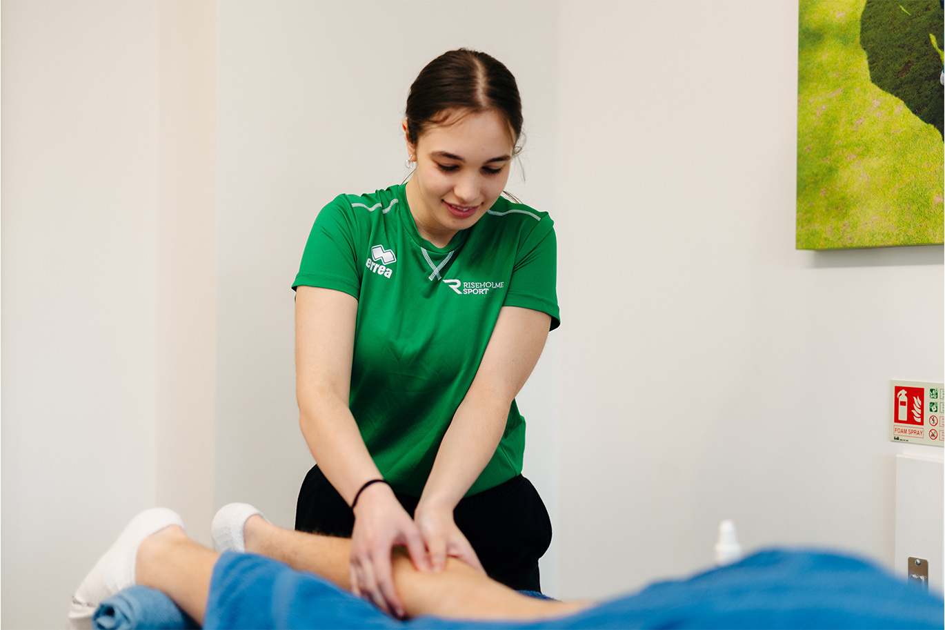 Sport student giving a sports massage