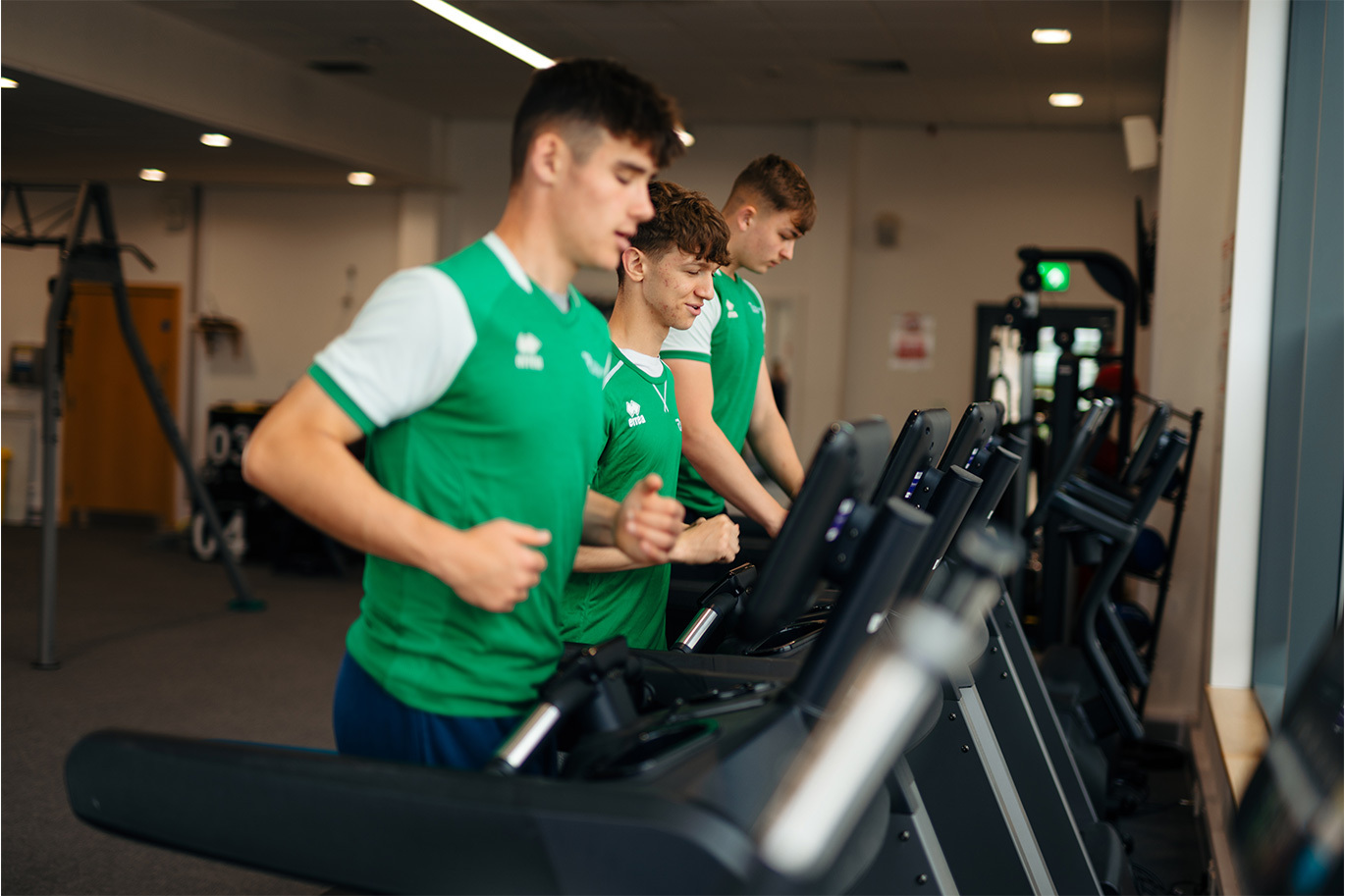 Sport students jogging on treadmill in gym