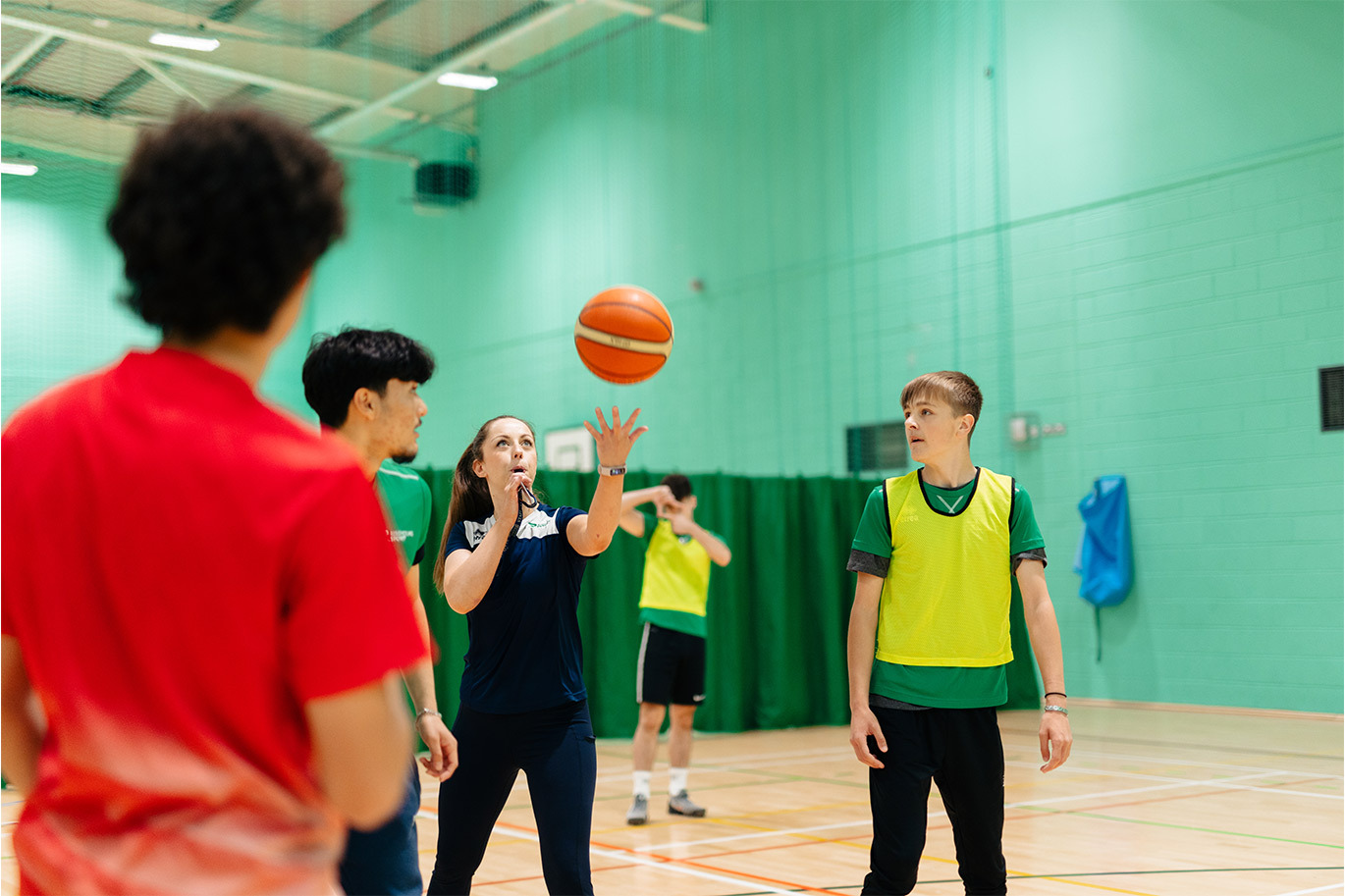 Sports tutor blowing on the whistle to start game