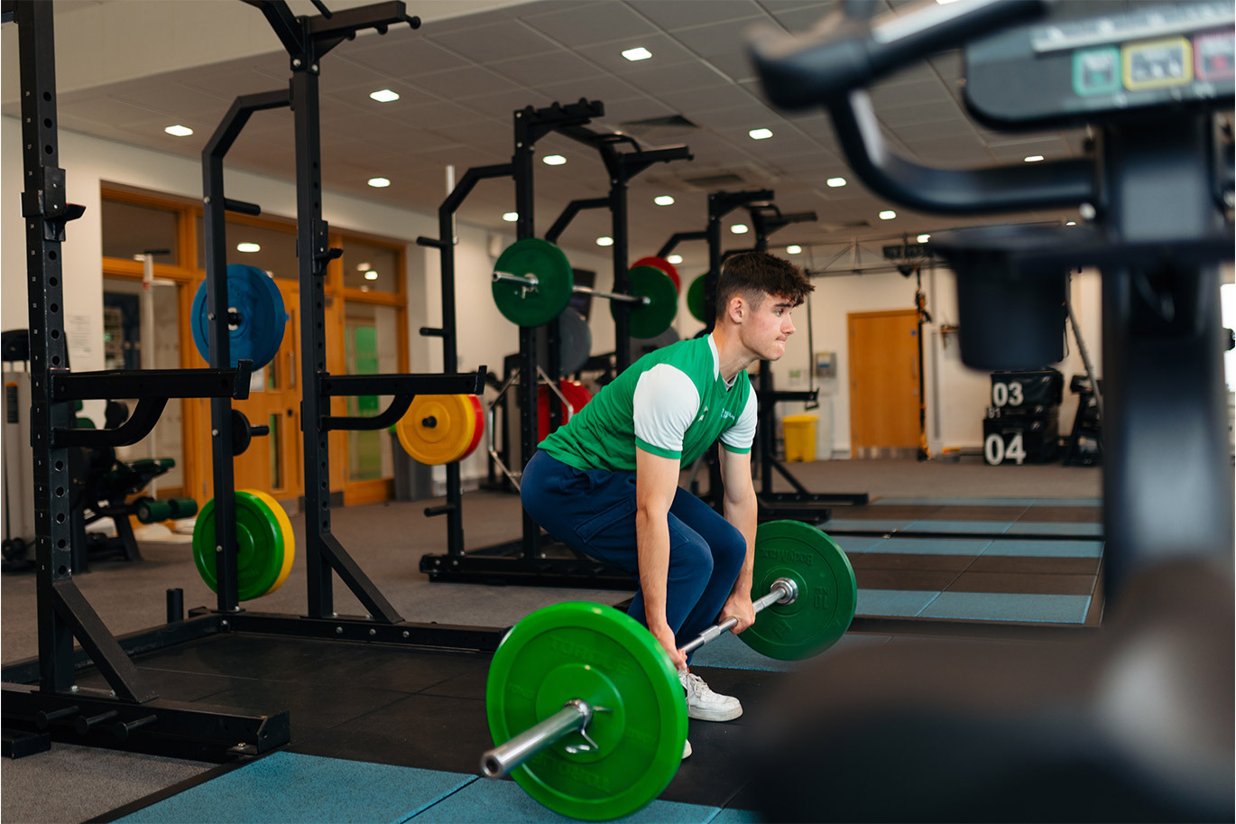 Student lifting weights in gym
